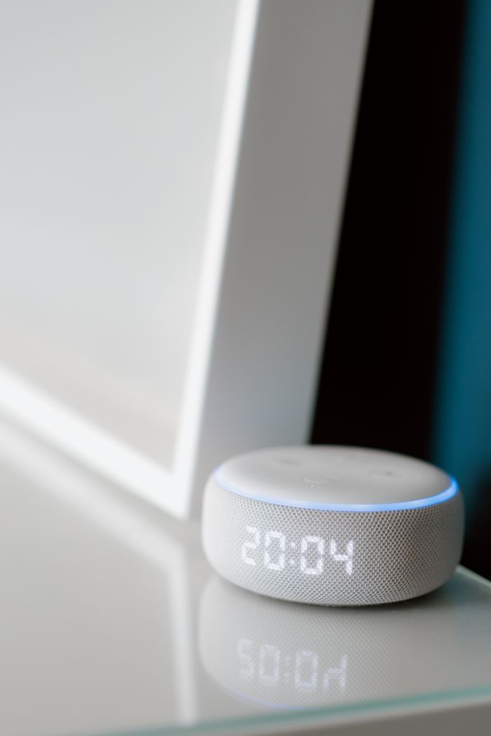 Home Close-up of a smart speaker with digital time display indoors.
